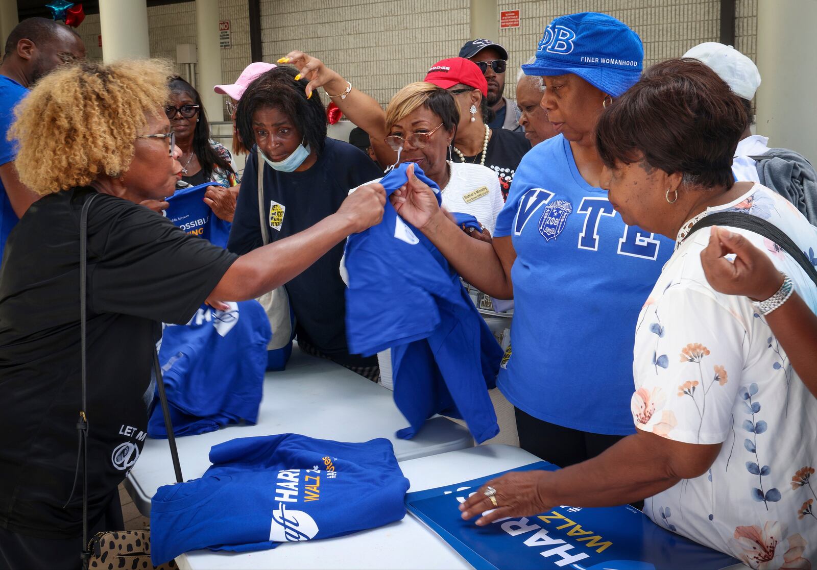 Voters and attendees gather around for t-shirts in support of the Harris-Walz ticket at the Joseph Caleb Center during the "Souls to the Polls" event on Sunday, Nov. 3, 2024, the last day of early voting in Miami. (Carl Juste/Miami Herald via AP)