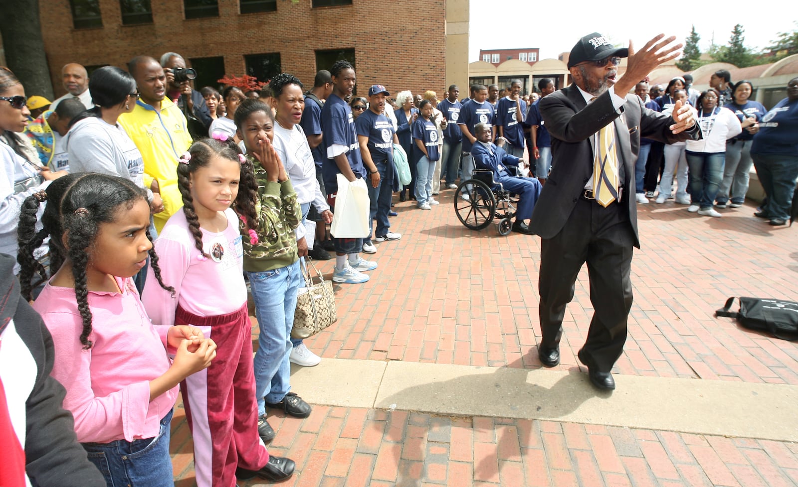 The Rev. Fred Taylor, right, SCLC director of field operations, leads a small crowd in song prior to a wreath-laying ceremony at the tomb of Martin Luther King, Jr. and Coretta King in this 2007 photo. (BITA HONARVAR / AJC staff)