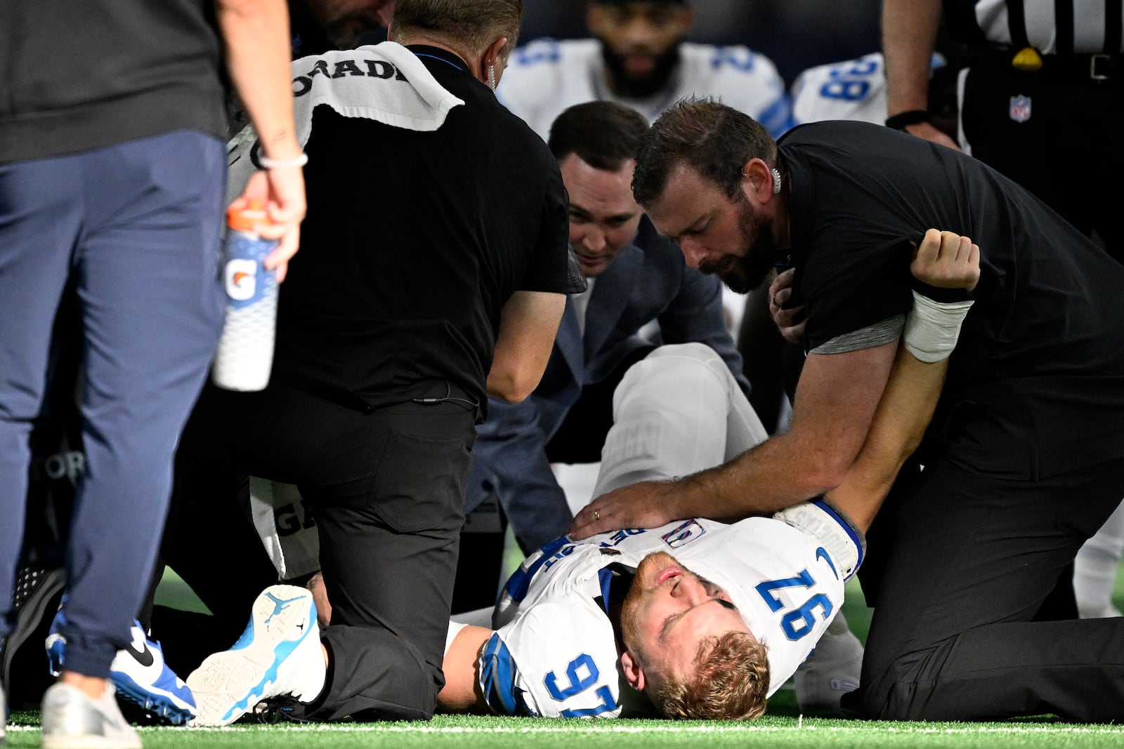 Detroit Lions defensive end Aidan Hutchinson (97) is attended to by team staff after suffering an unknown injury second half of an NFL football game against the Dallas Cowboys in Arlington, Texas, Sunday, Oct. 13, 2024. (AP Photo/Jerome Miron)