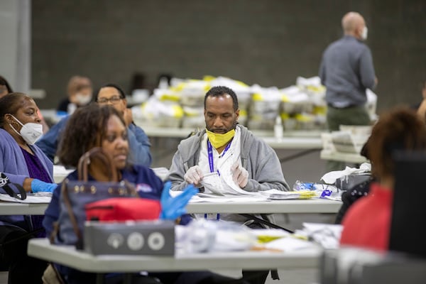 06/09/2020 - Atlanta, Georgia  - Fulton County employees open and prepare to scan mail-in ballots to be counted at the Georgia World Congress Center during the Georgia primary elections, Tuesday, June 9, 2020. (ALYSSA POINTER / ALYSSA.POINTER@AJC.COM)