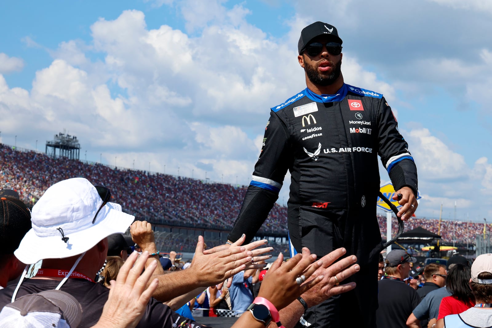 Driver Bubba Wallace greets fans before a NASCAR Cup Series auto race at Talladega Superspeedway, Sunday, Oct. 6, 2024, in Talladega, Ala. (AP Photo/ Butch Dill)