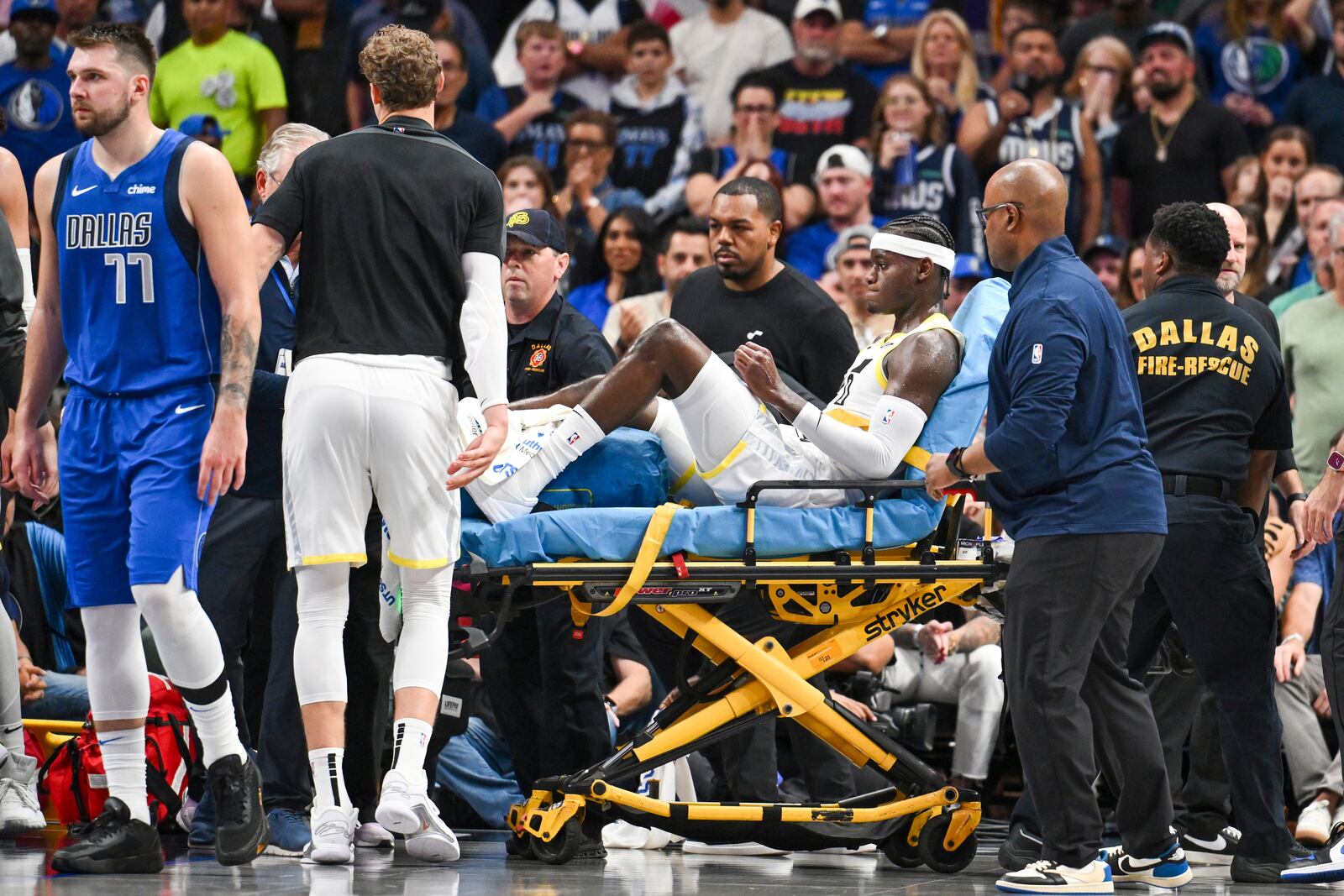 Utah Jazz forward Taylor Hendricks (0) is carried off by paramedics after sustaining an injury in the second half during an NBA basketball game against the Dallas Mavericks, Monday, Oct. 28, 2024, in Dallas. (AP Photo/Albert Pena)