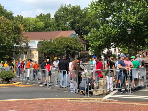 Small numbers of onlookers have arrived on the square in Dahlonega to the area reserved for counterdemonstrators. (Photo: Chris Joyner/AJC)