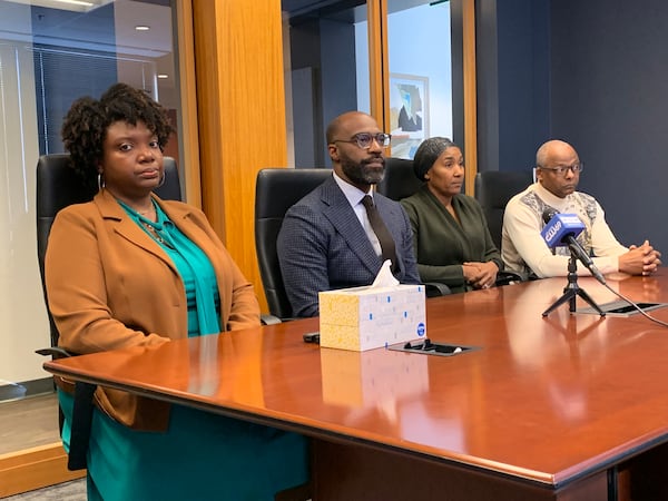 Plaintiffs Keyania Otobor (left) and Pamela and Aubrey Williams (right) flank attorney Michael Smith at a press conference Nov. 17, 2022 to discuss a discrimination lawsuit they filed against Trilith Development and Trilith Studios in Fayetteville. RODNEY HO/rho@ajc.com