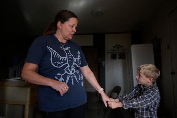 Erin Young wears a Holy Spirit T-shirt as she talks with her adopted son Isaac, 5, at home on Tuesday, Nov. 12, 2024, in Sunbury, Ohio. (AP Photo/Carolyn Kaster)