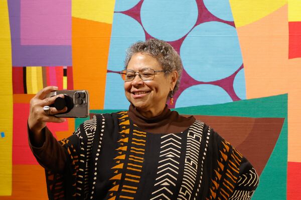 Photographer Susan “Sue” Ross takes a selfie during the VIP reception for the museum’s latest exhibition “Threaded” on Thursday, Feb. 1, 2024. (Natrice Miller/ Natrice.miller@ajc.com)