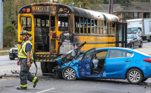 A driver faces charges after causing a fiery school bus crash Thursday morning, March 30, 2017, Sandy Springs police said. Students walked away with only bumps and bruises in the accident, which shut down most of Roswell Road, according to the WSB 24-hour Traffic Center. 