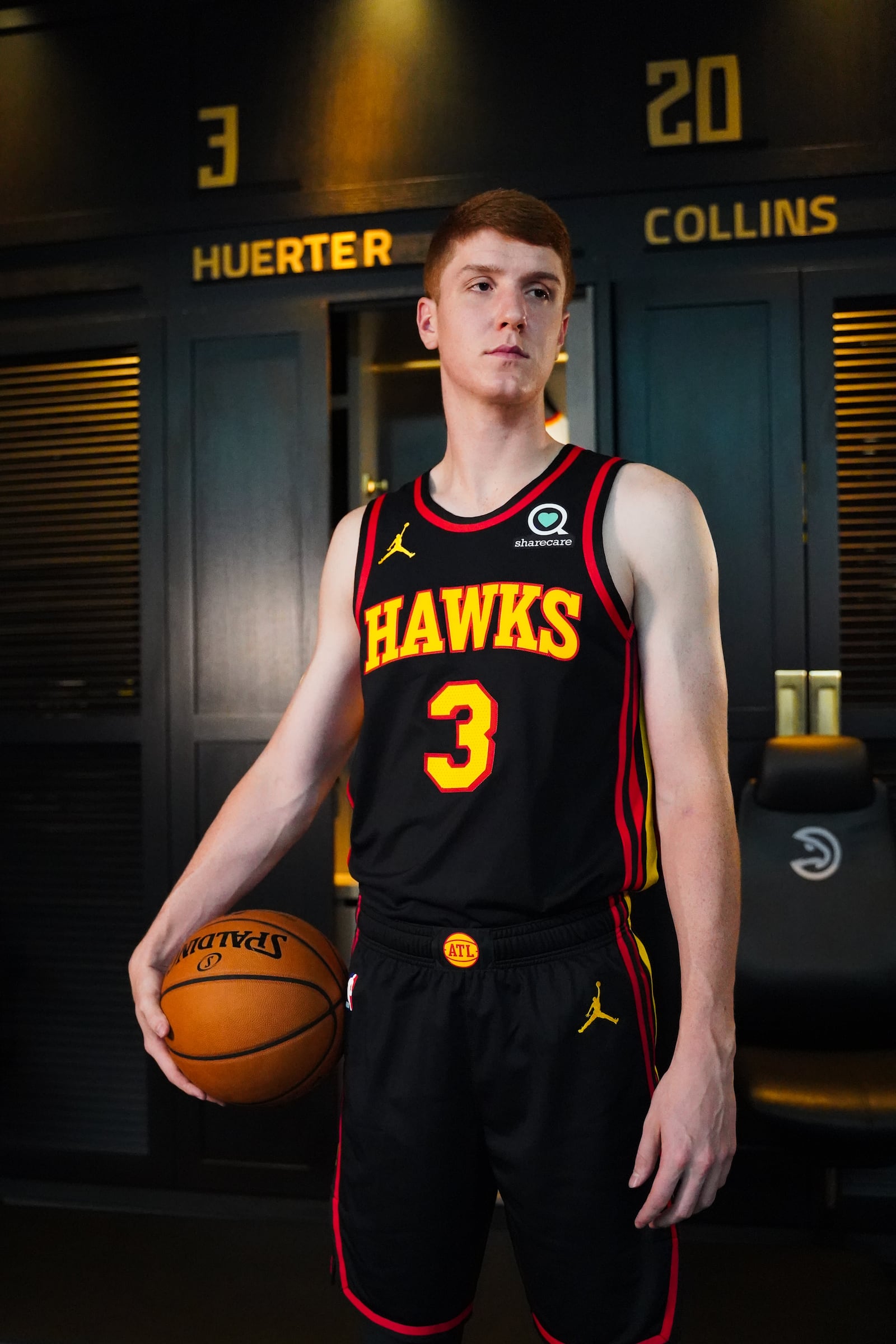 Hawks guard Kevin Huerter models the "infinity black" uniforms for next NBA season.