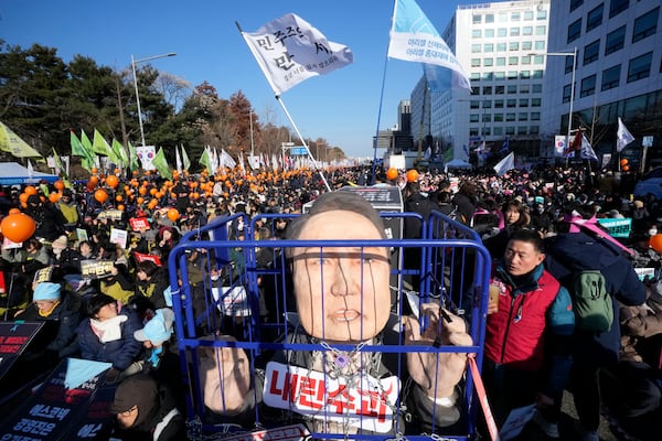 A caricature depicting an imprisoned South Korean President Yoon Suk Yeol is displayed before a rally to demand his impeachment outside the National Assembly in Seoul, South Korea, Saturday, Dec. 14, 2024. (AP Photo/Ahn Young-joon)