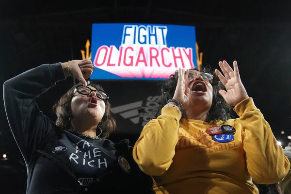 People cheer for Sen. Bernie Sanders, I-Vt., and Rep. Alexandria Ocasio-Cortez, D-N.Y., during a "Fighting Oligarchy" tour event at Arizona State University, Thursday, March 20, 2025, in Tempe, Ariz. (AP Photo/Ross D. Franklin)