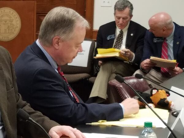 State Sen. John Wilkinson, R-Toccoa, sits with the stuffed dog his colleague gave him during the Senate Rules Committee. Maya T. Prabhu/maya.prabhu@ajc.com