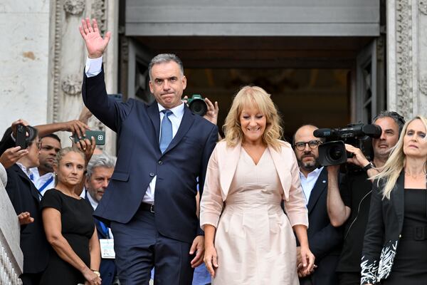 Uruguay's incoming President Yamandu Orsi and Vice President Carolina Cosse exit the Congress building after they attended their swearing ceremony, on Inauguration Day in Montevideo, Uruguay, Saturday, March 1, 2025. (AP Photo/Santiago Mazzarovich)