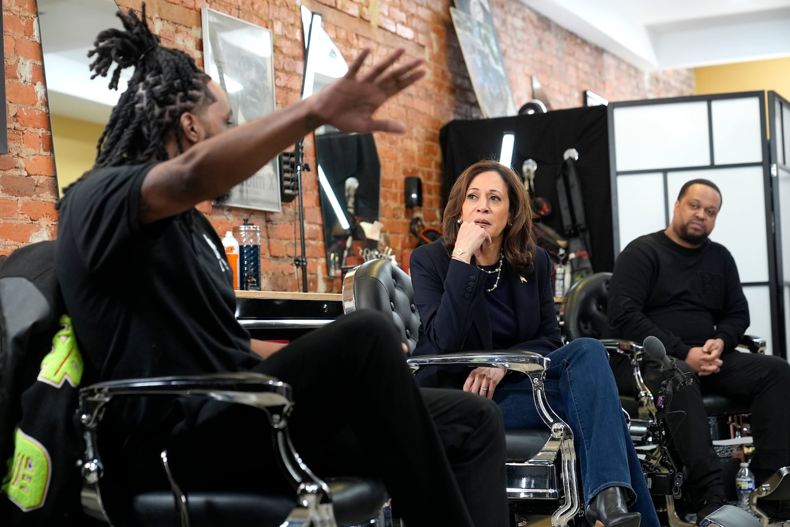 Democratic presidential nominee Vice President Kamala Harris, center, sits in conversation with Black men at Philly Cuts barbershop during a campaign stop, Sunday, Oct. 27, 2024, in Philadelphia. (AP Photo/Susan Walsh)