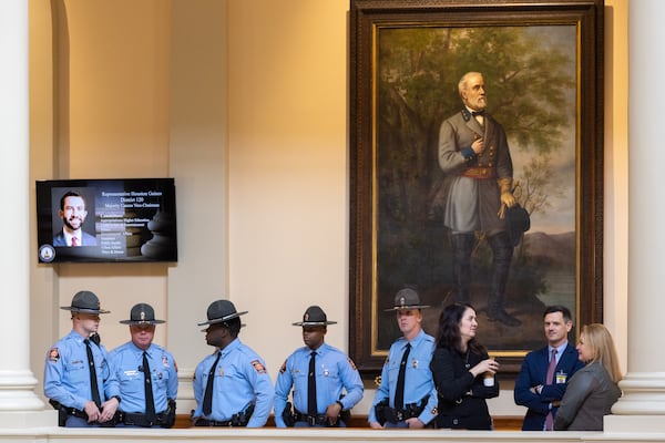 Increased law enforcement gathers in front of a portrait of Robert E. Lee on the first day of the legislative session in the Capitol in Atlanta on Monday, January 8, 2024, following a bomb threat the previous week. (Arvin Temkar / arvin.temkar@ajc.com)