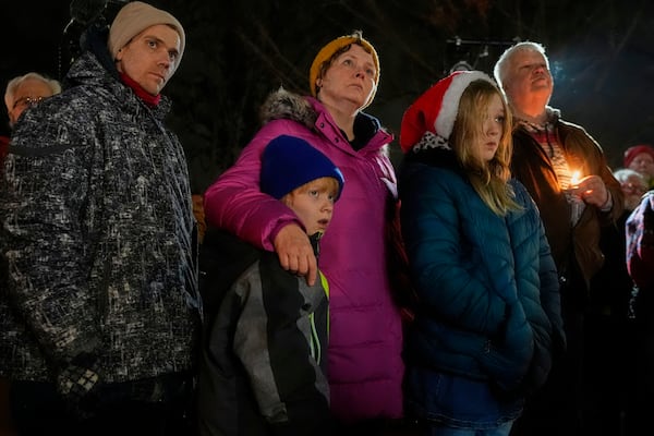 Supporters hold candles during a candlelight vigil Tuesday, Dec. 17, 2024, outside the Wisconsin Capitol in Madison, Wis., following a shooting at the Abundant Life Christian School on Monday, Dec. 16. (AP Photo/Morry Gash)