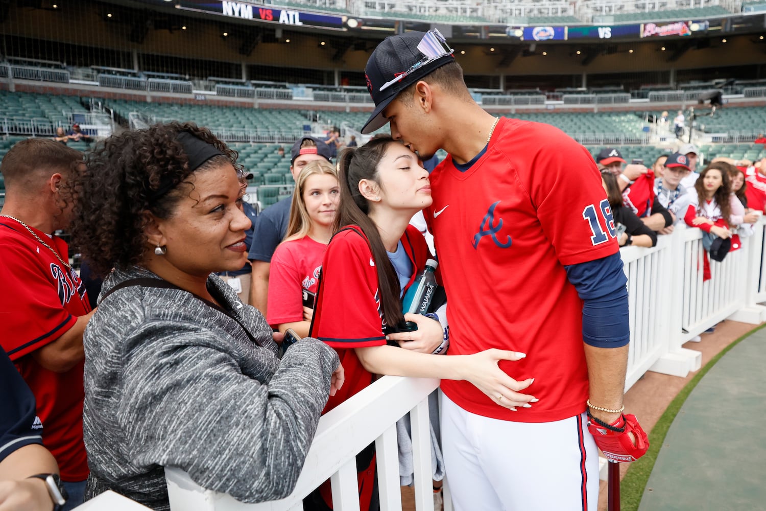 Atlanta Braves second baseman Vaughn Grissom (18) kisses the forehead of his partner Dalton Kendall before the second game of the series between the Atlanta Braves and the New York Mets at Truist Park on Saturday, Oct. 1, 2022. Miguel Martinez / miguel.martinezjimenez@ajc.com 