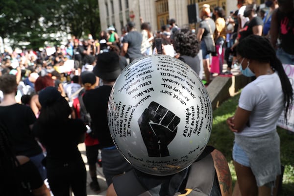 Cori Barniak stands in the crowd with names of African Americans that have died from police brutality written on her motorcycle helmet while joining a rally at Atlanta City Hall on Sunday, June 7, 2020. (Photo: Alyssa Pointer/AJC)