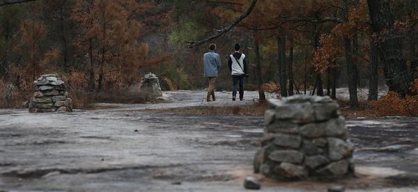 Matt Trivett (right) of Decatur and Jon Chames of Clarkston follow stone path markers while hiking a section of the Arabia Mountain Trail southeast of Atlanta near Lithonia. The PATH Trails network meanders through rock outcroppings, colorful wildflower fields, rushing streams, and towering pines from the Mall at Stonecrest into Panola Mountain State Park and beyond featuring 7,000 acres of green space and Arabia Mountain. CURTIS COMPTON / CCOMPTON@AJC.COM