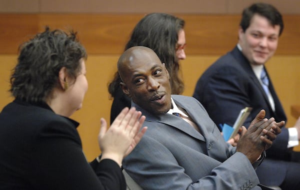 Aimee Maxwell (left), executive director of the Georgia Innocence Project, claps after Willie O. "Pete" Williams was legally cleared by Fulton County Judge Thomas Campbell.