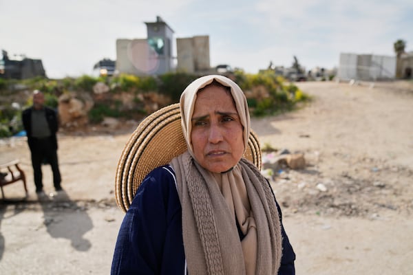 An elderly Palestinian woman leaves after she was not allowed to cross from the Israeli military Qalandia checkpoint near the West Bank city of Ramallah to Jerusalem, to participate in the Friday prayers at the Al-Aqsa Mosque compound during the Muslim holy month of Ramadan on Friday, March 14, 2025. (AP Photo/Nasser Nasser)