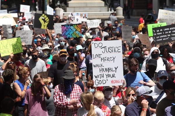 Crowds from OneRace’s “March on Atlanta” Juneteenth observance which kicked off at Centennial Olympic Park rallies for racial justice and equality at the state Capitol on Friday, June 19, 2020.   