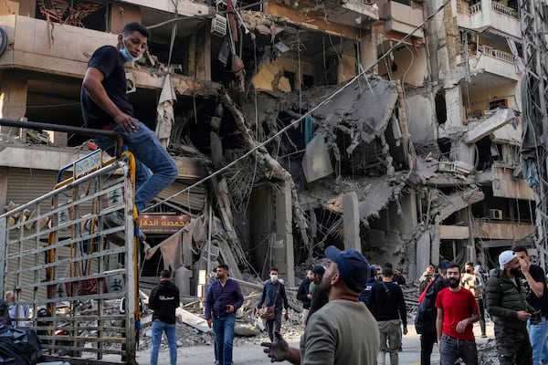 Residents check the site of an Israeli airstrike in Dahiyeh, Beirut, Lebanon, Saturday, Nov. 9, 2024. (AP Photo/Hassan Ammar)