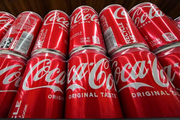 FILE - Cans of Coca-Cola are on display at a grocery market in Uniontown, Pa, April 24, 2022. (AP Photo/Gene J. Puskar, File)