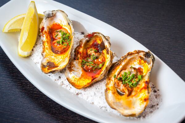 The grilled oysters with lemon butter and smoked paprika at Simon’s Restaurant in Midtown didn’t please our reviewer. CONTRIBUTED BY CHRISTOPHER WATKINS