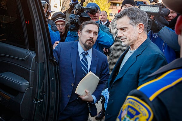 Attorney Kevin Miller, left, helps client Fotis Dulos enter a car outside Stamford Superior Court after Dulos was released on a $6-million bond on Jan. 9 in Samford, Conn.