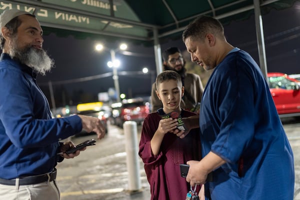 Hassan Abdel Salam, left, with the Abandon Harris movement, hands out flyers asking people to vote for Green Party presidential candidate Jill Stein as they leave evening prayers at the Islamic Center of Detroit, Monday, Nov. 4, 2024, in Detroit, Mich. (AP Photo/David Goldman)