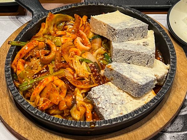 Spicy stir-fried squid comes with firm tofu at Dubu Gongbang. Henri Hollis/henri.hollis@ajc.com