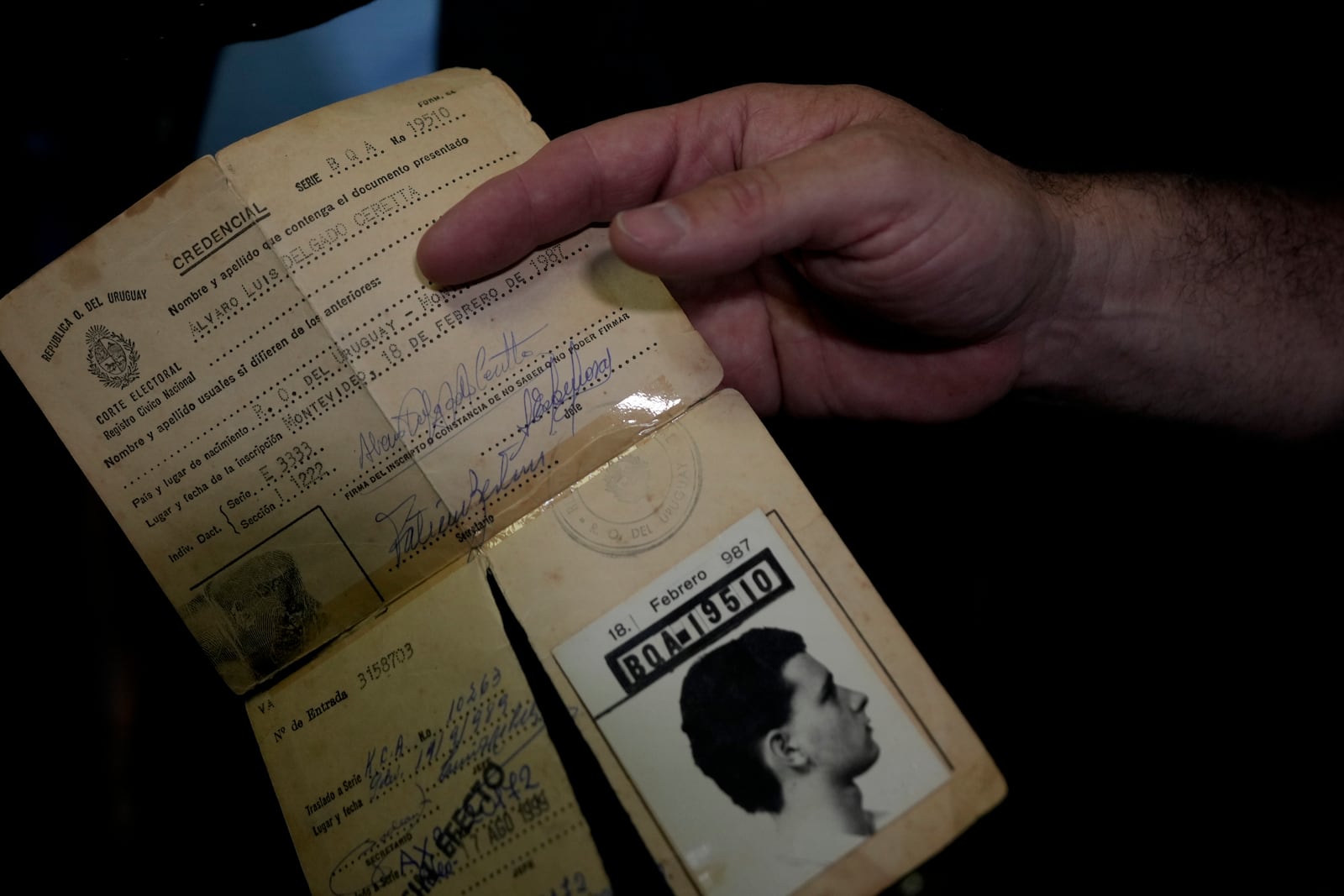 Alvaro Delgado, presidential candidate for the ruling National Party, holds out his voting document at a polling station during general elections in Montevideo, Uruguay, Sunday, Oct. 27, 2024. (AP Photo/Natacha Pisarenko)