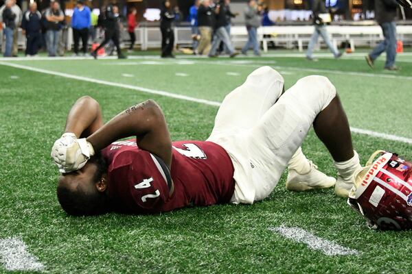 Warner Robins player Jahlen Rutherford lays dejected after their class 5A high school championship football game against Bainbridge, Tuesday, Dec., 11, 2018, at Mercedes-Benz Stadium, in Atlanta. Bainbridge won 47-41 in 3 overtimes. (John Amis/Special)