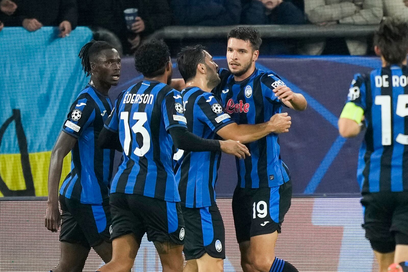 Atalanta's Berat Djimsiti celebrates with his teammates after scoring the opening goal during the Champions League opening phase soccer match between Shakhtar Donetsk and Atalanta at the Arena AufSchalke in Gelsenkirchen, Germany, Wednesday Oct. 2, 2024. (AP Photo/Martin Meissner)