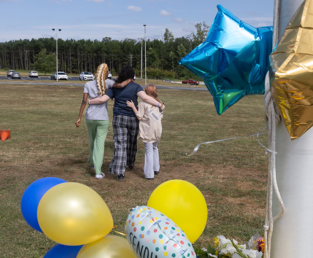 Students and well wishers depart after leaving flowers to place at the flag pole at Apalachee High School in Winder on Thursday, Sept. 5, 2024. A 14-year-old is accused of shooting and killing two fellow students and two teachers and injuring nine others at Apalachee High School on Wednesday. (John Spink/AJC)