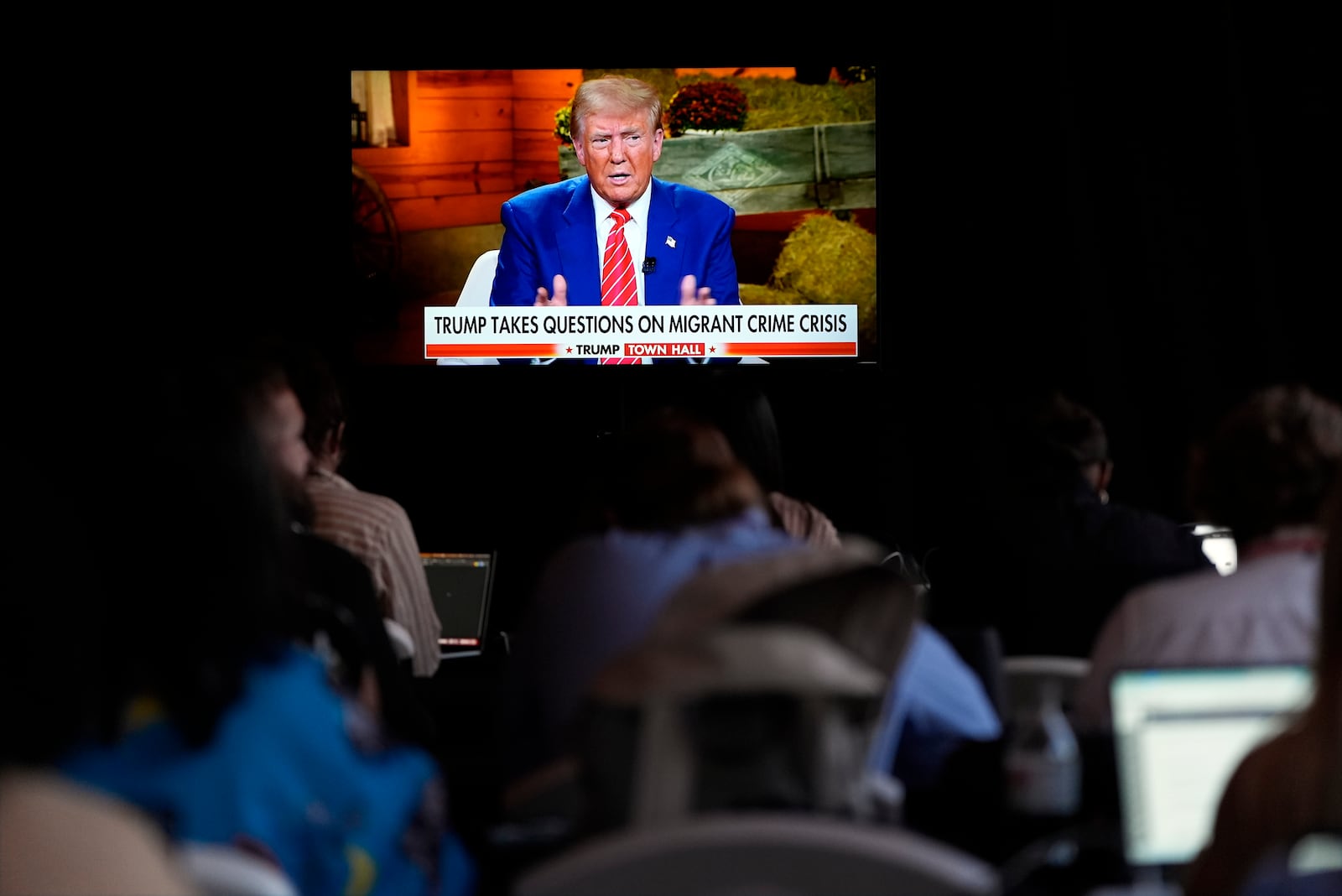 Reporters watch as former President Donald Trump, the Republican presidential nominee, speaks Tuesday during a Fox News town hall with Harris Faulkner at The Reid Barn in Cumming. (AP Photo/Julia Demaree Nikhinson)