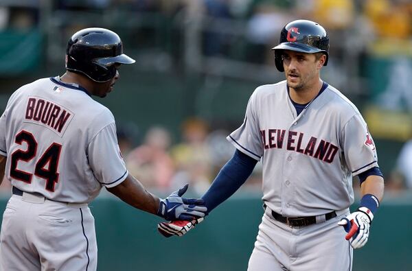 Cleveland Indians' Lonnie Chisenhall, right, is congratulated by Michael Bourn (24) after hitting a home run off Oakland Athletics' Aaron Brooks in the fifth inning of a baseball game Saturday, Aug. 1, 2015, in Oakland, Calif. (AP Photo/Ben Margot)