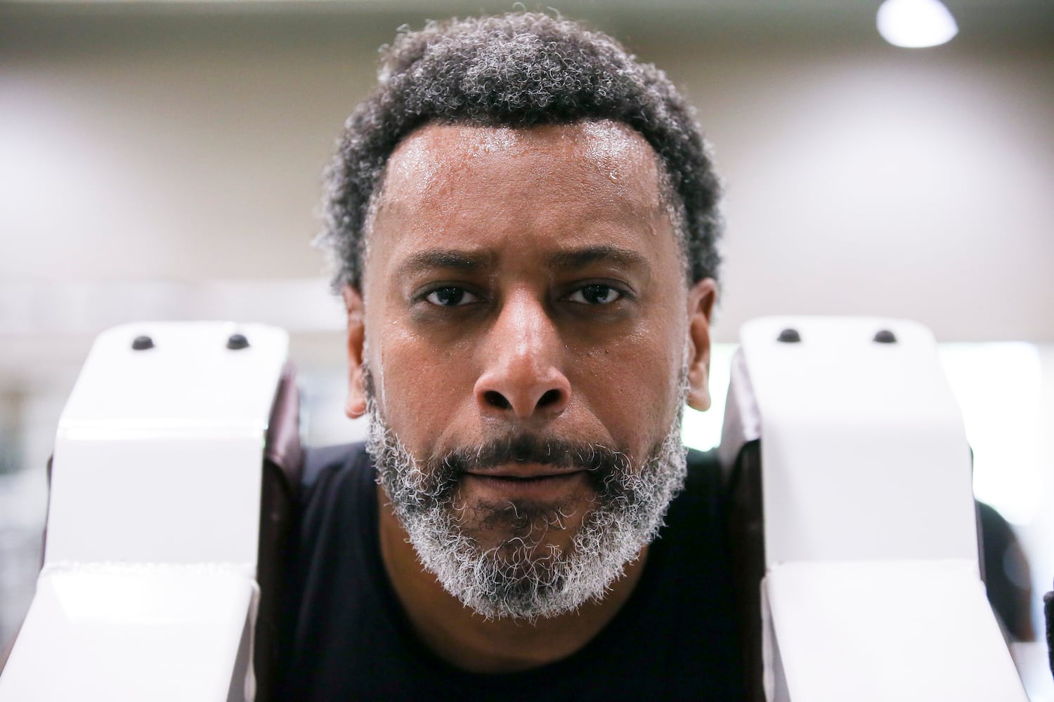 Tiran Jackson uses a machine to do squats at Life Time Woodstock on Wednesday, July 6, 2022, in Woodstock, Georgia. Tiran Jackson said fitness is important to him to ensure he can continue to walk and maintain his balance with his leg and prosthetic. (Chris Day/Christopher.Day@ajc.com)