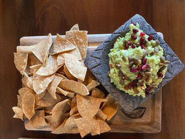 The guacamole at D Boca N Boca is garnished with pomegranate seeds and pepitas. Ligaya Figueras/ligaya.figueras@ajc.com  