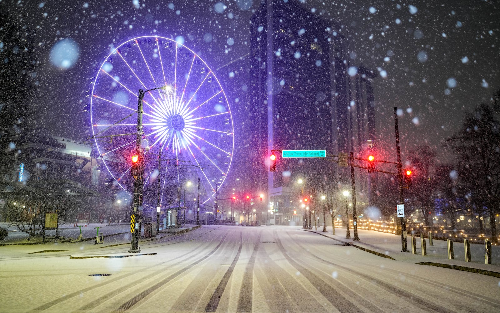 Snow falls on Centennial Olympic Park Drive in Downtown Atlanta, Georgia. Friday, January 10, 2025 (Ben Hendren for the Atlanta Journal-Constitution)