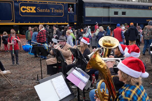 Members of the Twin Springs high school band perform during the 82nd run of the CSX Santa Train, Saturday, Nov. 23, 2024, in Dungannon, Va. (AP Photo/George Walker IV)