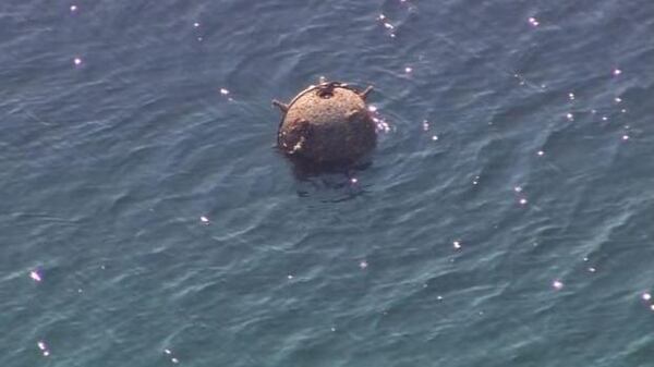 A photo of the rusty, floating mine in Puget Sound.