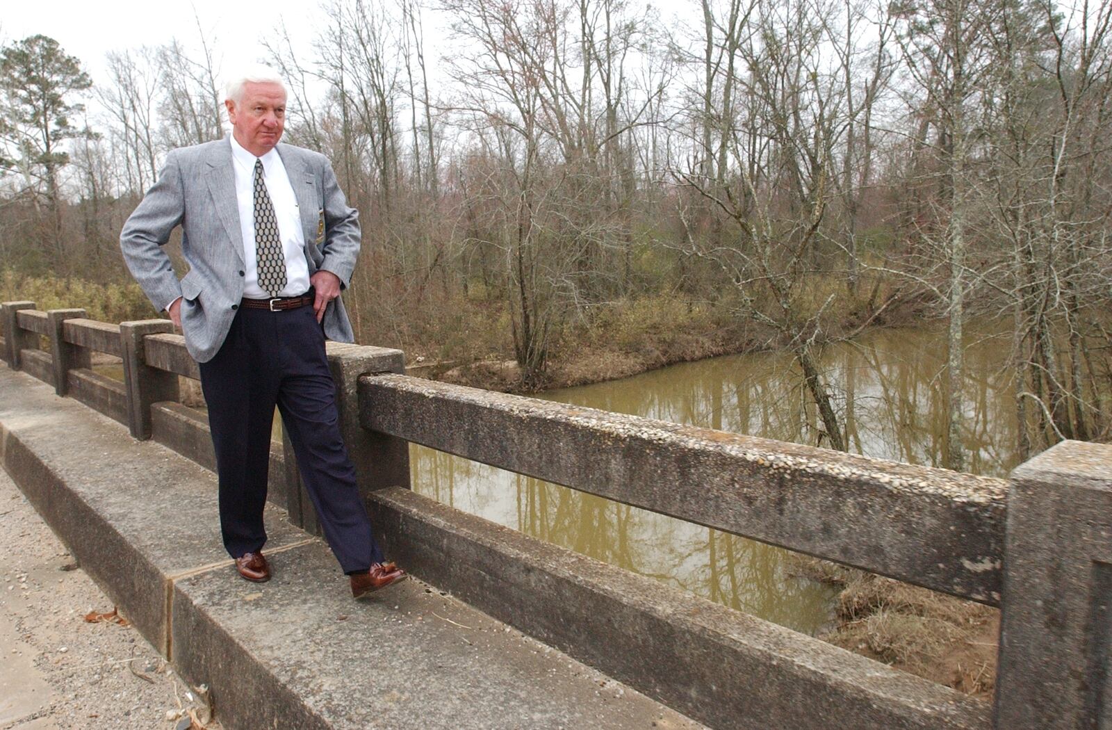 2003 -- Fayette County Sheriff Randall Johnson walks across the bridge over the Flint River at the Clayton/Fayette county line. In 1977 four murders took place and the two of the bodies were found here and the case was cracked with DNA evidence in 2003. (MARLENE KARAS/AJC staff)