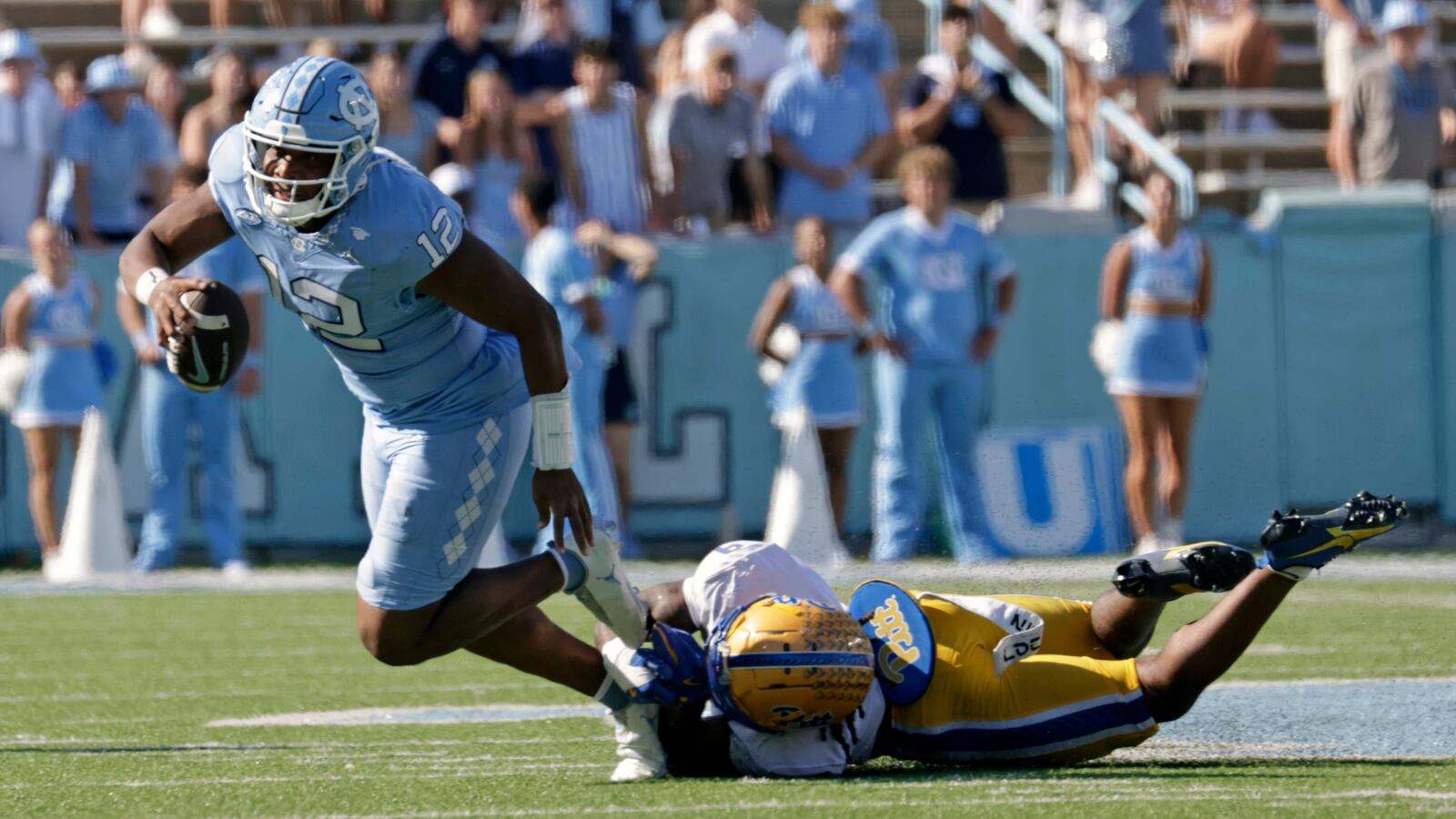 Pittsburgh linebacker Kyle Louis (9) trips up North Carolina quarterback Jacolby Criswell (12) on fourth down to cause a turnover on downs during the second half of an NCAA college football game Saturday, Oct. 5, 2024, in Chapel Hill, N.C. (AP Photo/Chris Seward)