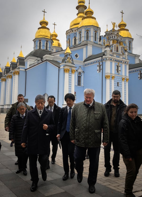 Japanese Foreign Minister Takeshi Iwaya and his Ukrainian counterpart Andriiy Sybiha pass by St. Michael Monastery in Kyiv, Ukraine, Saturday, Nov. 16, 2024. (AP Photo/Efrem Lukatsky)