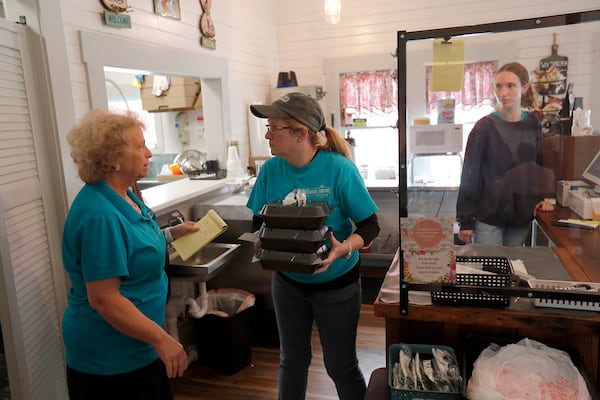 Owners Donna Boyles and Rebecca Tebeau prepare take out orders at Central Station in Springfield.