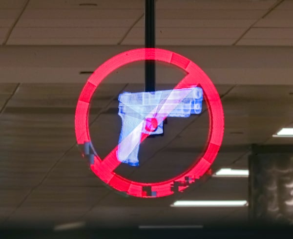 April 1, 2022: Hartsfield-Jackson International Airport: A Hologram displays no weapons at the security gate at Hartsfield-Jackson International Airport  (John Spink / John.Spink@ajc.com)

