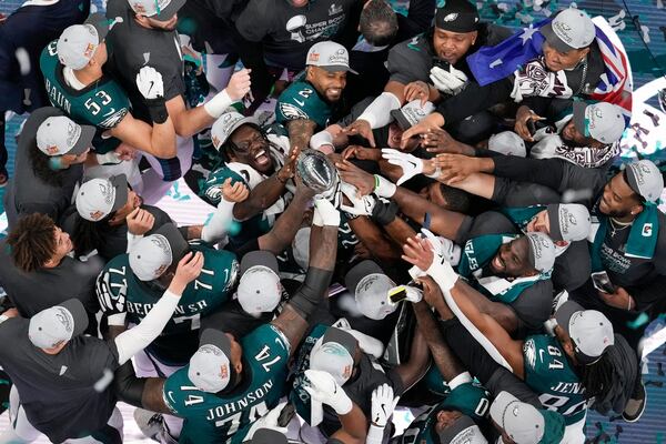 Eagles players celebrate with the Vince Lombardi Trophy after their Super Bowl win in New Orleans.