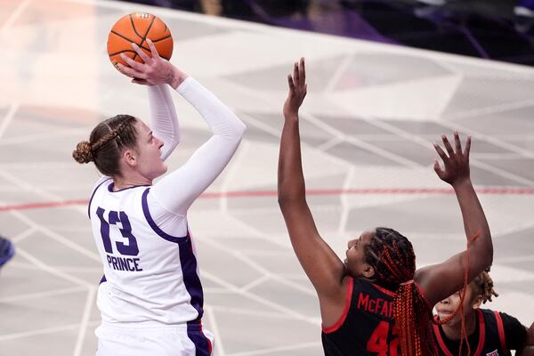 TCU center Sedona Prince (13) shoots over Houston forward Peyton McFarland, right, in the second half of an NCAA college basketball game in Fort Worth, Texas, Wednesday, Feb. 26, 2025. (AP Photo/Tony Gutierrez)