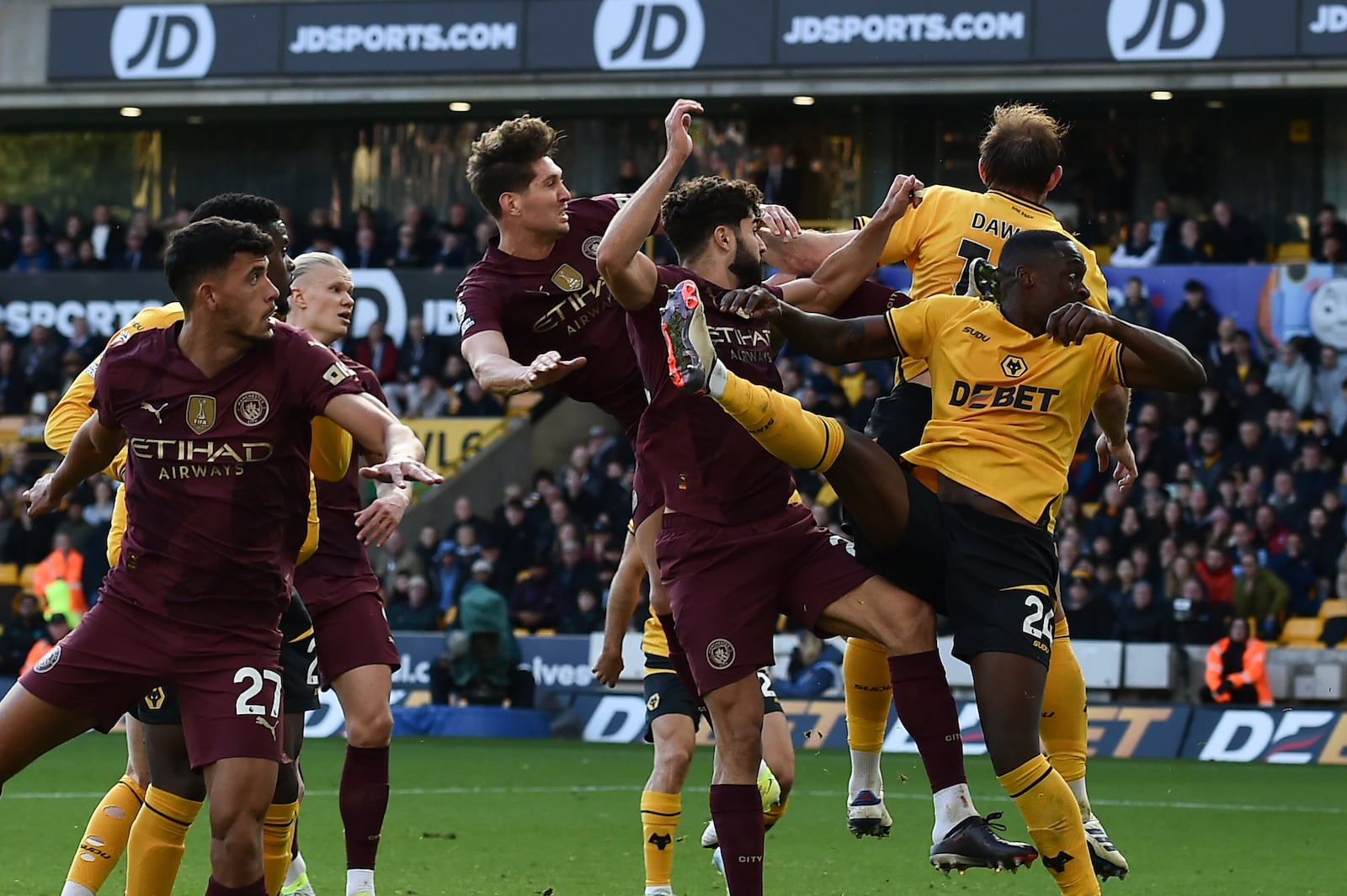 Manchester City's John Stones, top left, scores his side's 2nd goal during the English Premier League soccer match between Wolverhampton Wanderers and Manchester City at the Molineux Stadium in Wolverhampton, England, Sunday, Oct. 20, 2024. (AP Photo/Rui Vieira)